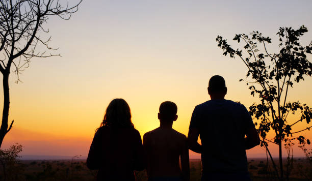 Silhouettes of a family watching the beautiful sunset in Mikumi National Park.