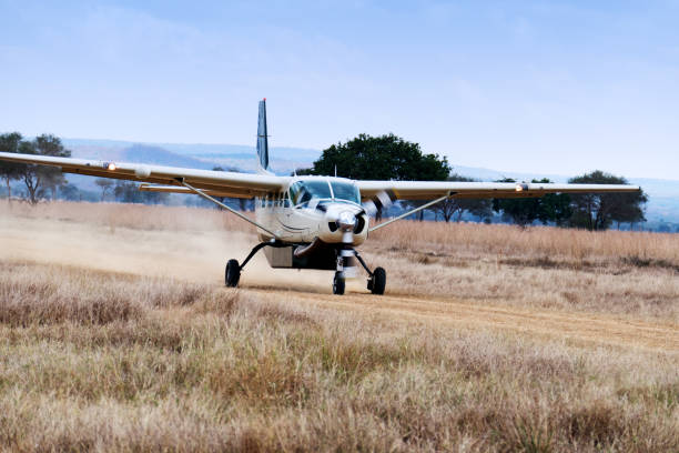 Mikumi National Park, Tanzania - August 05, 2018:A  Cessna 208 B Grand Caravan with tourists  is arriving at the bush airstrip of the Mikumi National Park. The safari charter is from Safari Airlink. This airline is offering flights to remote areas in Southern Tanzania.