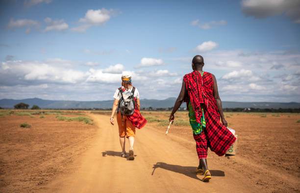 Same, Tanzania, 7th June, 2019: people walking on a dusty road in Maasai land in Tanzania