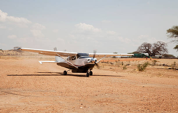 Safari flight ready to take off on Ruaha airstrip, Tanzania. It is midday and the shadows are directly under the plane.