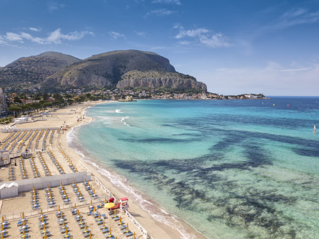 Aerial view of Mondello Beach located near Palermo, Sicily.  Many umbrellas on the beach.