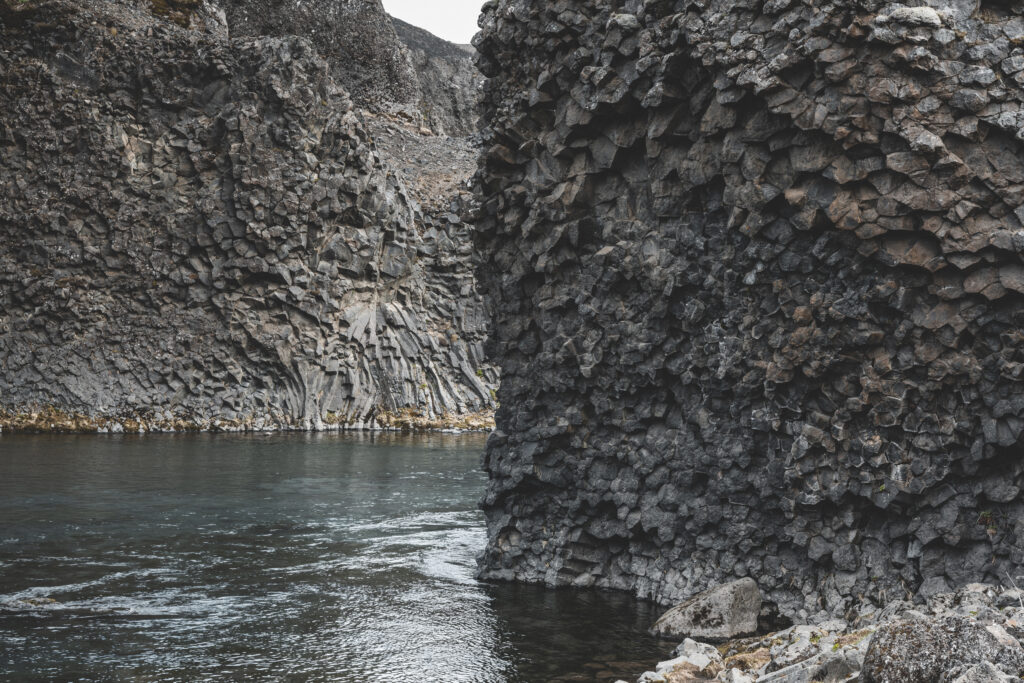 The basalt column formation around the Hjalparfoss waterfall.