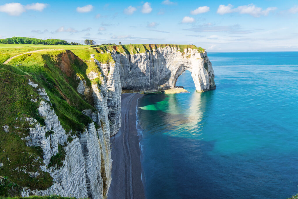 Beautiful cliffs Aval of Etretat, rocks and natural arch landmark of famous coastline, sea landscape of Normandy, France, Europe