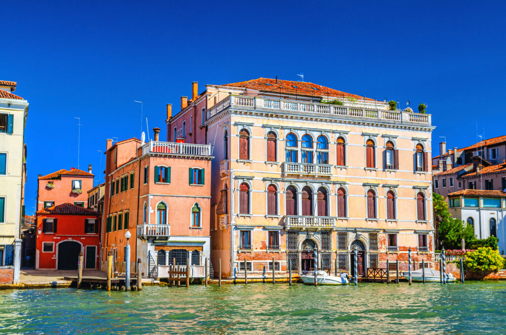 building in Cannaregio sestiere from Grand Canal waterway in Venice historical city center, blue clear sky background in summer day, Veneto Region, Italy