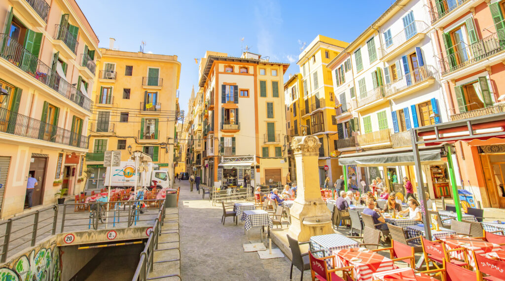 Palma de Mallorca, Spain - 30 August 2021: Old town panoramic view with summer street cafe