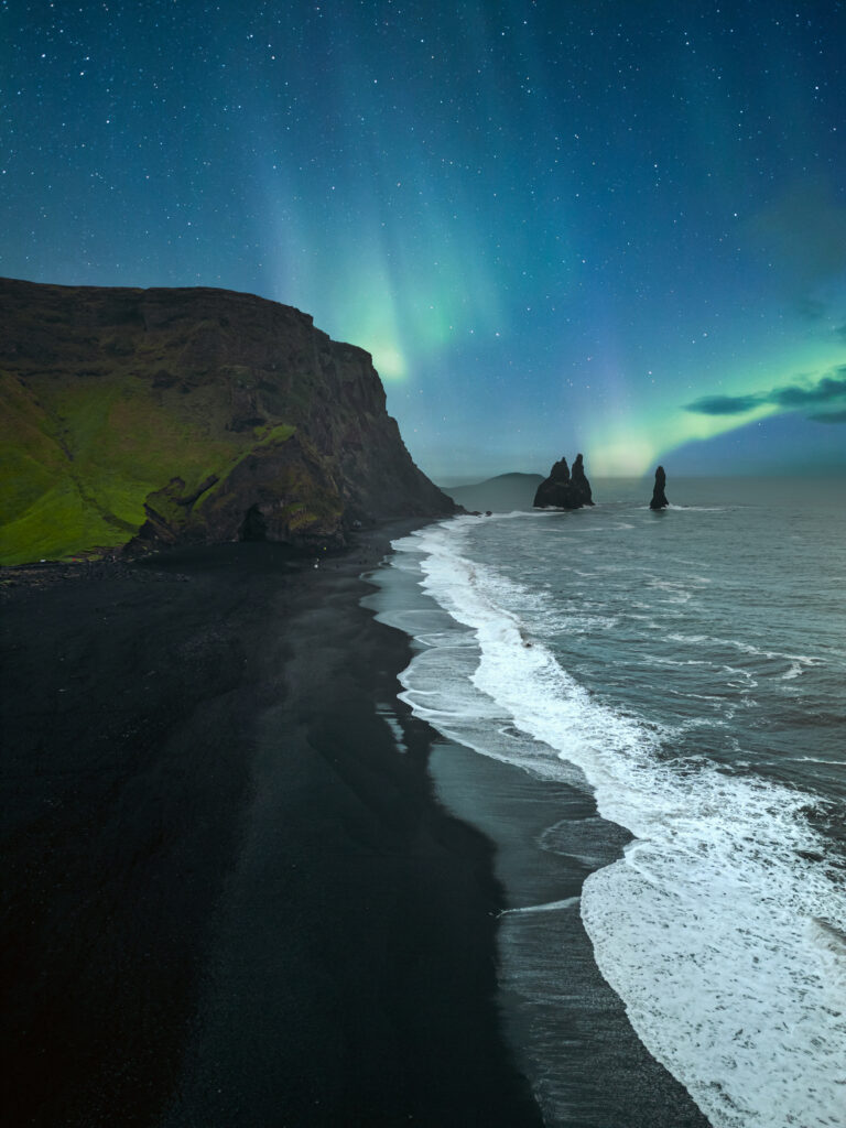 Reynisfjara is a world-famous black sand beach on the South Coast of Iceland. Basalt rocks Reynisdrangar, black volcanic sand and Atlantic ocean in Iceland