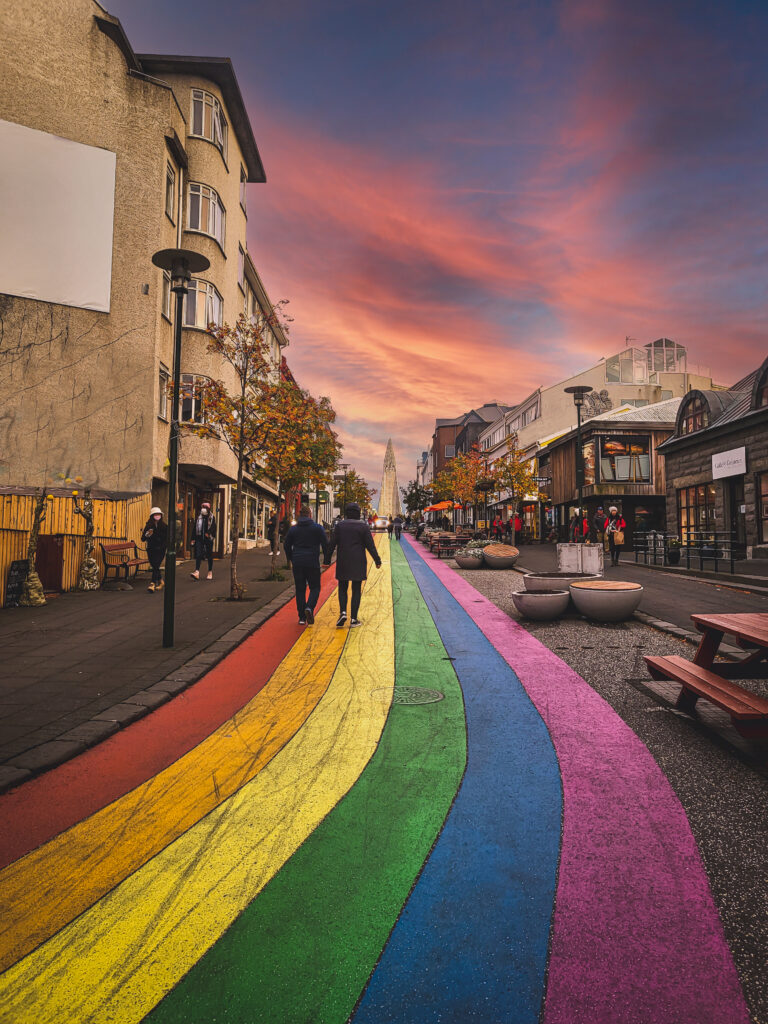 View up the famous Rainbow Street in Downtown Reykjavik Iceland. Halgrimskirka in the background.