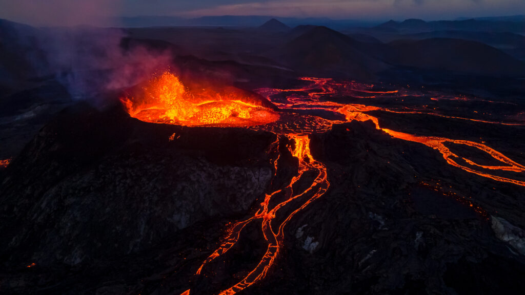 Beautiful aerial view of an active volcano with exploding red lava in Iceland