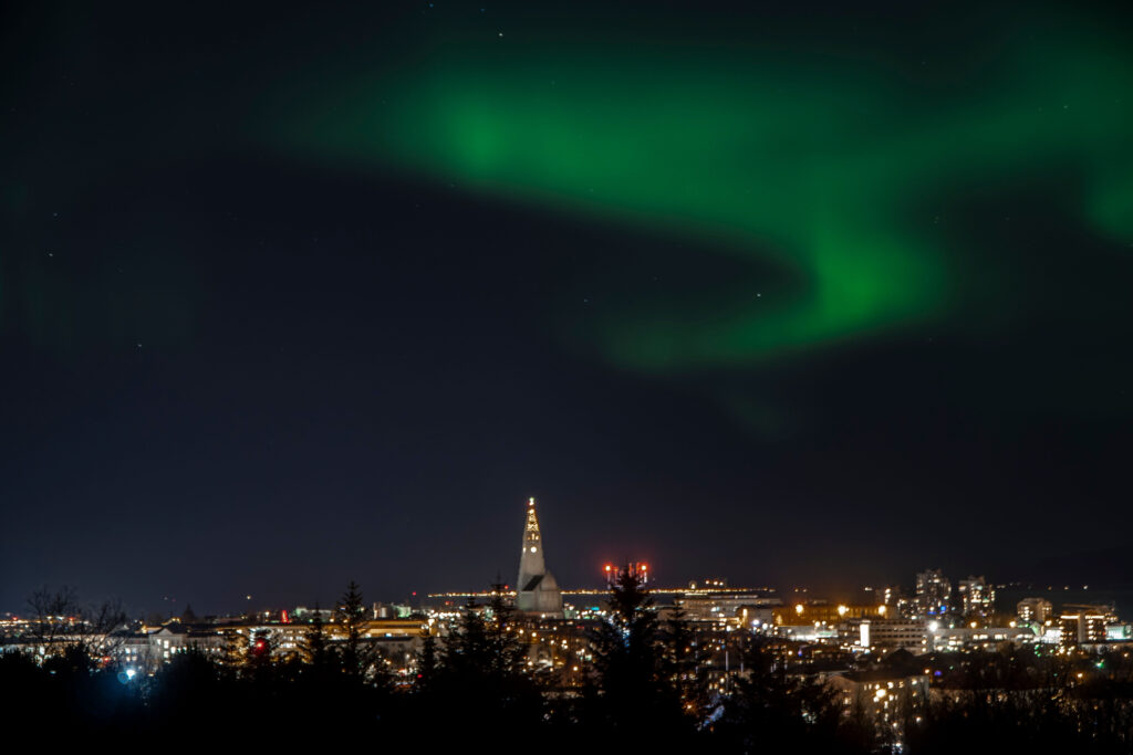 A beautiful shot of northern lights over Reykjavik