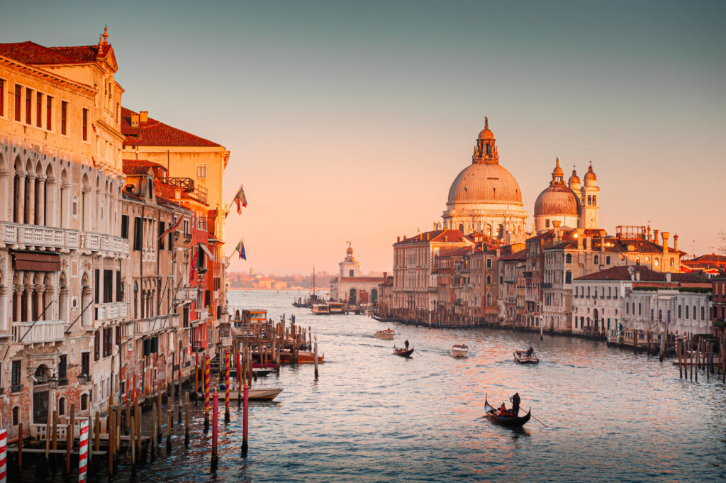 Grand Canal and Basilica Santa Maria della Salute in Venice, Italy. Beautifil cityscape at sunset. Famous tourist destination.