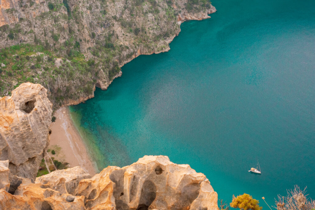 Top view of clear beach and transparent sea of Butterfly Valley. Butterfly Valley is one of the most beautiful beaches in Turkey