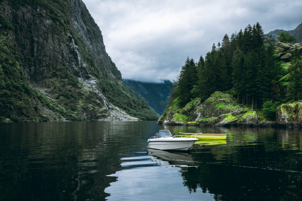 Moody landscape with boats in the Naeroyfjord from Gudvangen, Norway