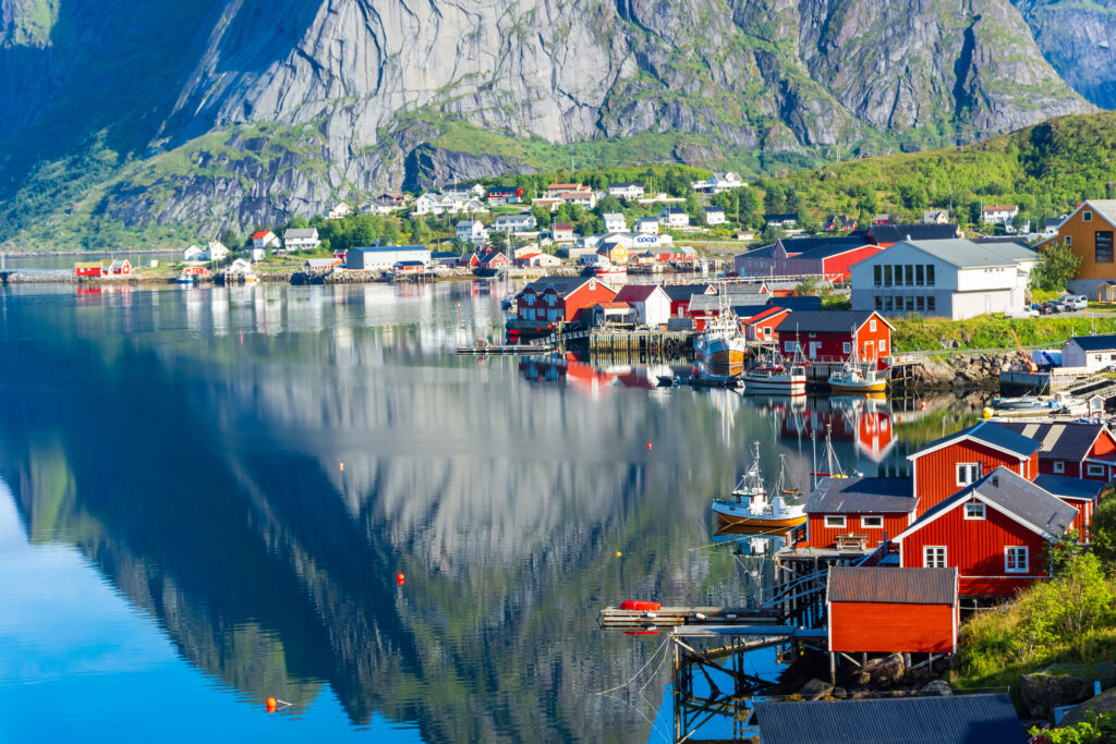 Perfect reflection of the Reine village on the water of the fjord in the Lofoten Islands, Norway