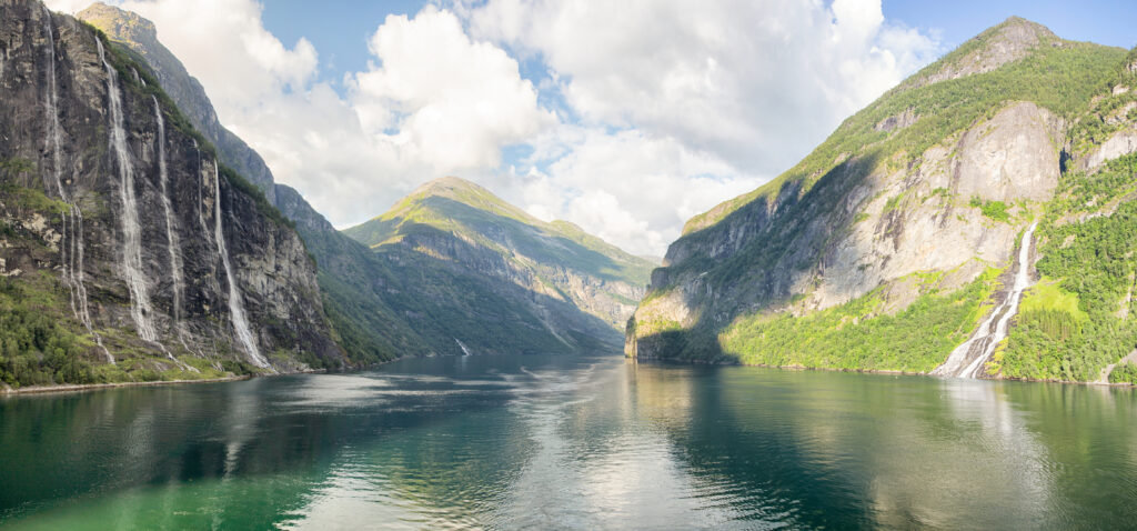 Panoramic shot of the famed Geirangerfjorde featuring The Seven Sisters and Suitor waterfalls