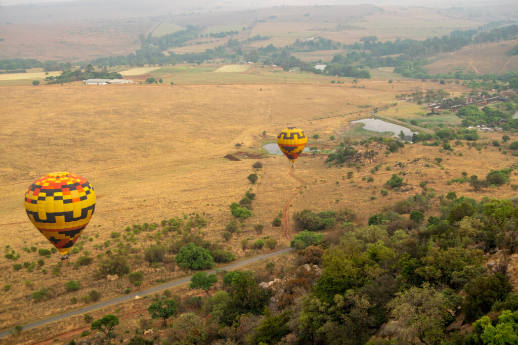 A bird'e eye view of hot air balloons in mid-flight