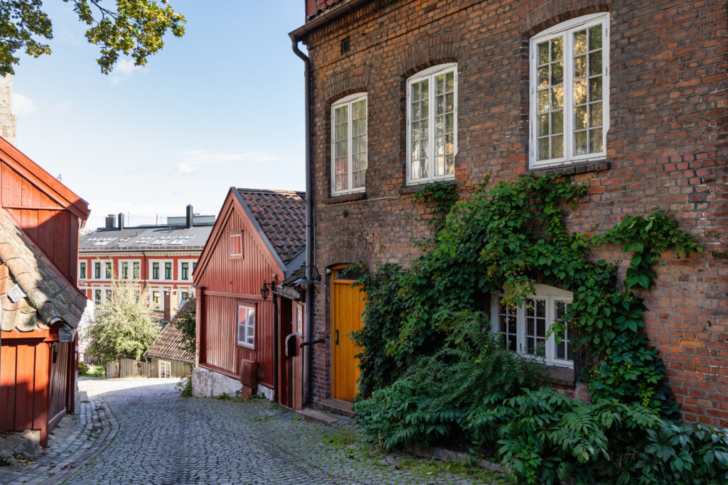 Norway Oslo Old Town Damstredet, typical old town houses in the old town village of Damstredet Cobblestone Street in Oslo in Summer. Damstredet Street is one of the oldest streets in the historic center of Oslo