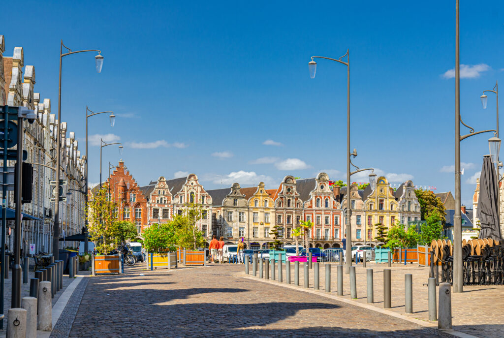 Arras cityscape with Flemish-Baroque-style townhouses buildings on La Grand Place square in old town center, blue sky in summer day, Pas-de-Calais department, Hauts-de-France Region, Northern France