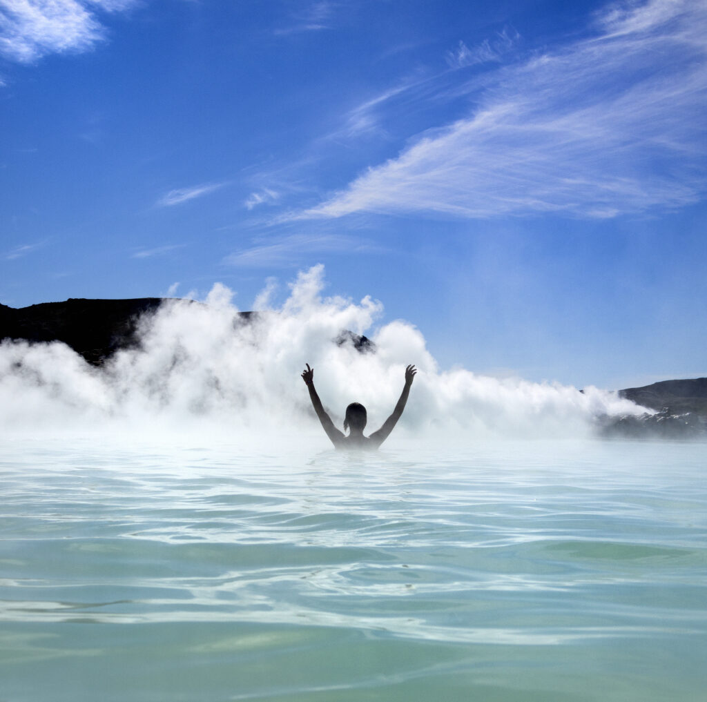 Person enjoying the hot spring of The Blue Lagoon on Iceland