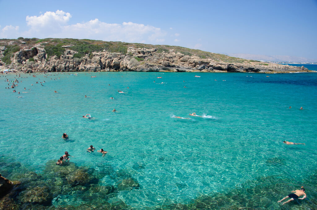 Noto, Italy - August 19, 2013: Calamosche Beach, near Noto in Sicily. Calamosche is situated inside the wonderful reserve of Vendicari, near Noto in Sicily (province of Siracusa). People are taking a bath, swimming, having fun.