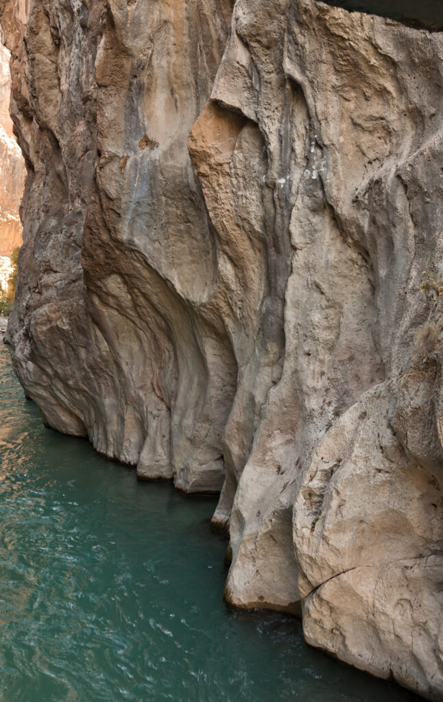 Saklıkent Canyon, located in the continent of Asia, is the second largest canyon in Europe, were Turkey actually in Europe. It is located in Muğla province in Turkey, 50 km from the city of Fethiye. The Canyon is 300 meters deep and 18 km long, resulting from the abrasion of the rocks by flowing waters over thousands of years. As the level of water rises during winter months, visitors can enter the canyon only in the summer. Four kilometers of the canyon are walkable after April, when most of the snow in the Taurus Mountains has melted and passed through on its way to the Mediterranean Sea. Saklıkent means "hidden city" in Turkish.