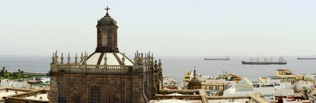 Panorama view from bell tower of Cathedral Santa Ana. On the background big industrial ships tanker waiting to enter the harbor. Downyard the historical city of Las Palmas de Gran Canaria (Canary Islands, Spain), Image made of 4 seperate image. HDR.