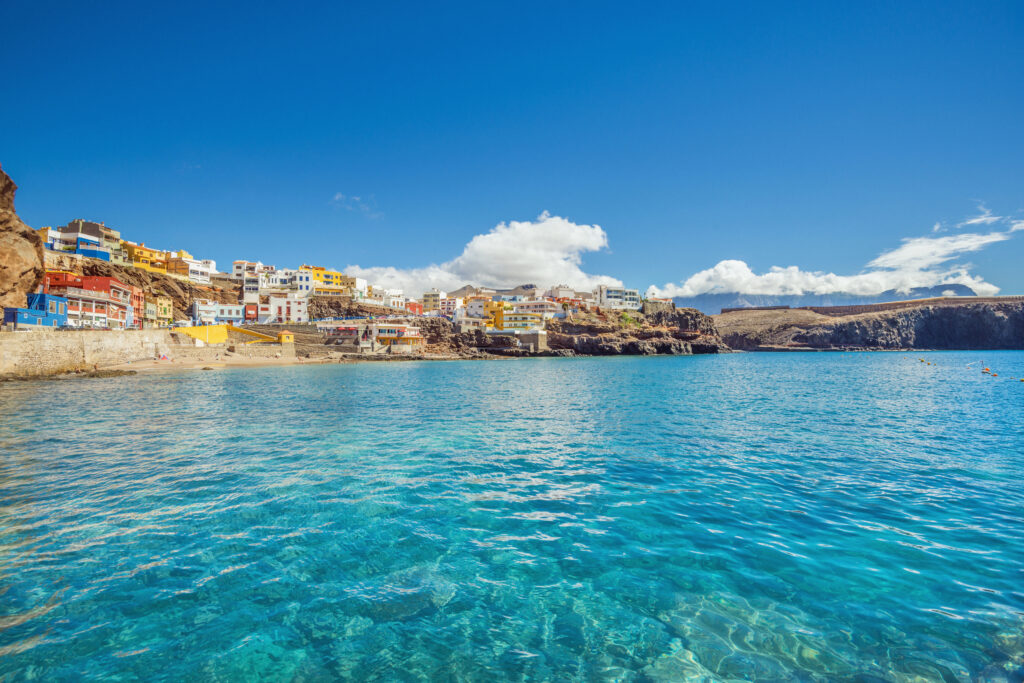 Crystal clear water and unspoiled canarian landscape at the beautiful fishing village of Sardina del Norte with its colorful houses.