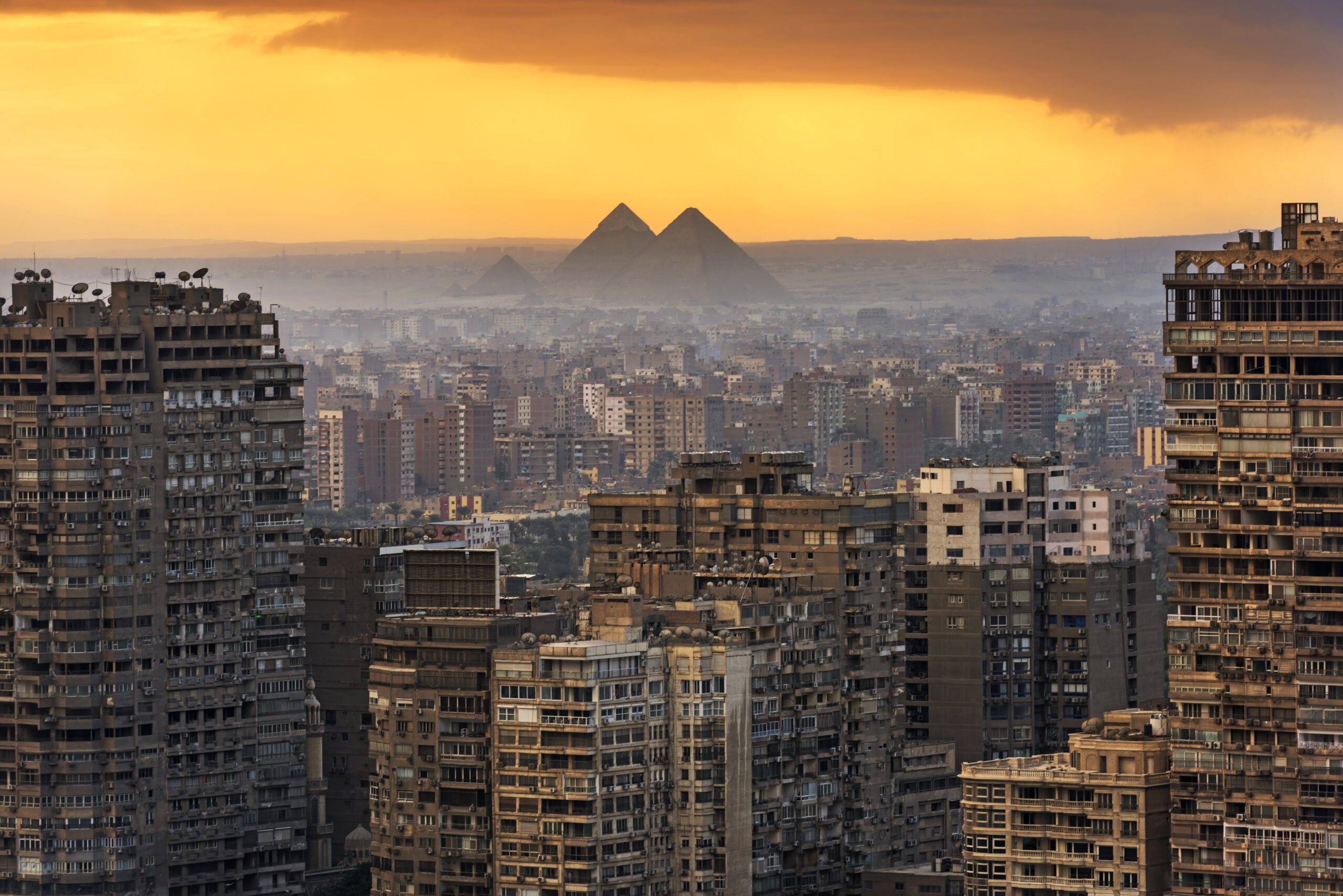 Landscape of Cairo,  with the Giza pyramids behind.