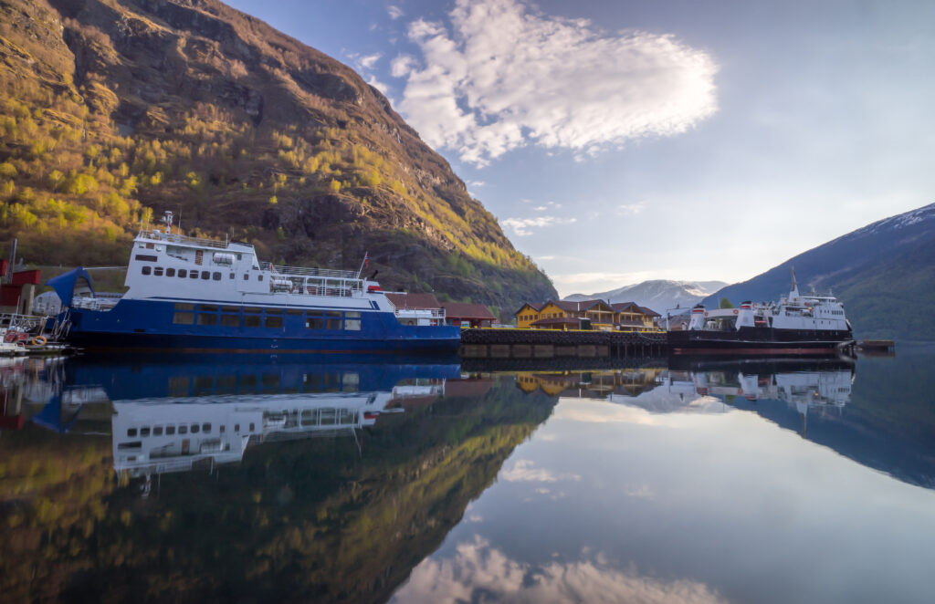 Flam village with Two cruise at the port during early morning and beautiful water reflection