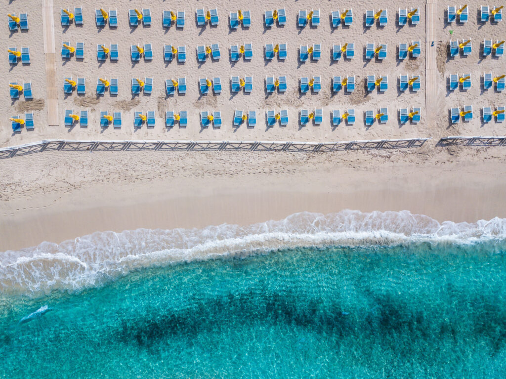 Aerial view of Mondello Beach located near Palermo, Sicily.  Many umbrellas on the beach.