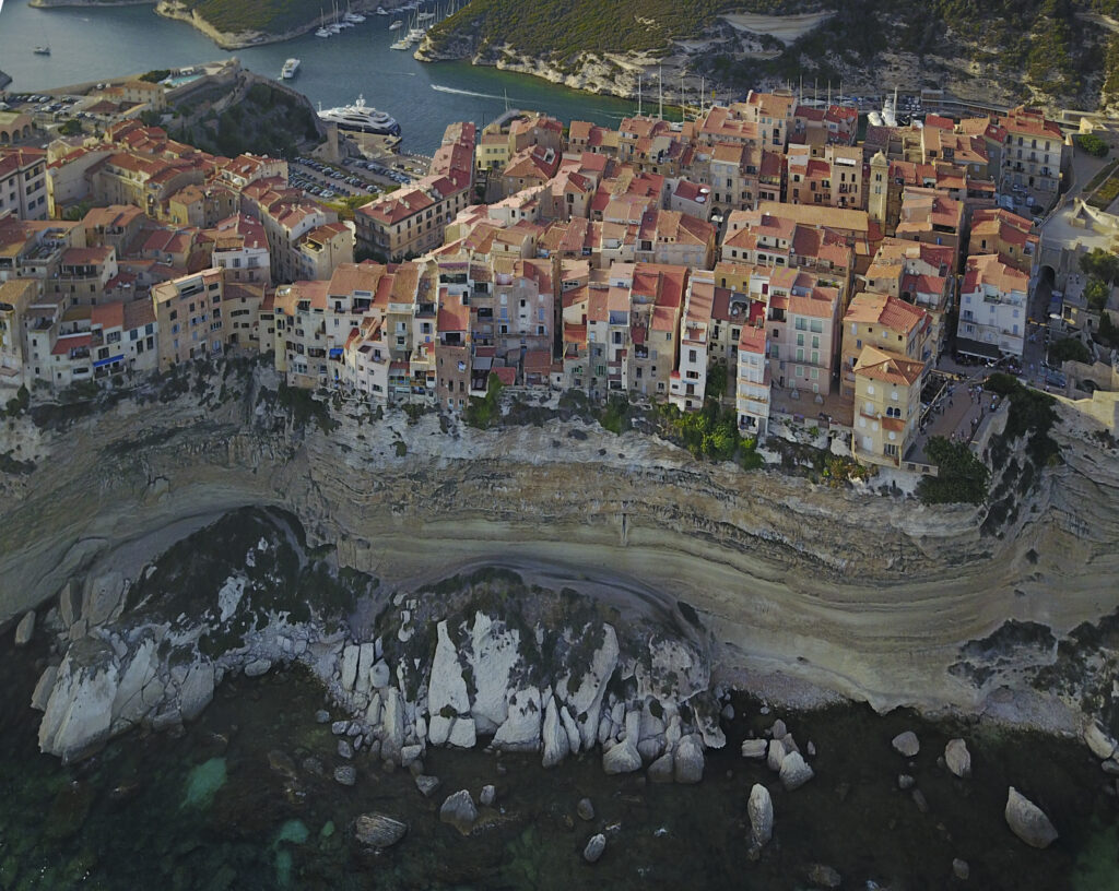 Aerial photograph of Bonifacio port in South of Corsica. Harbor. Limestone cliffs. Fortress.