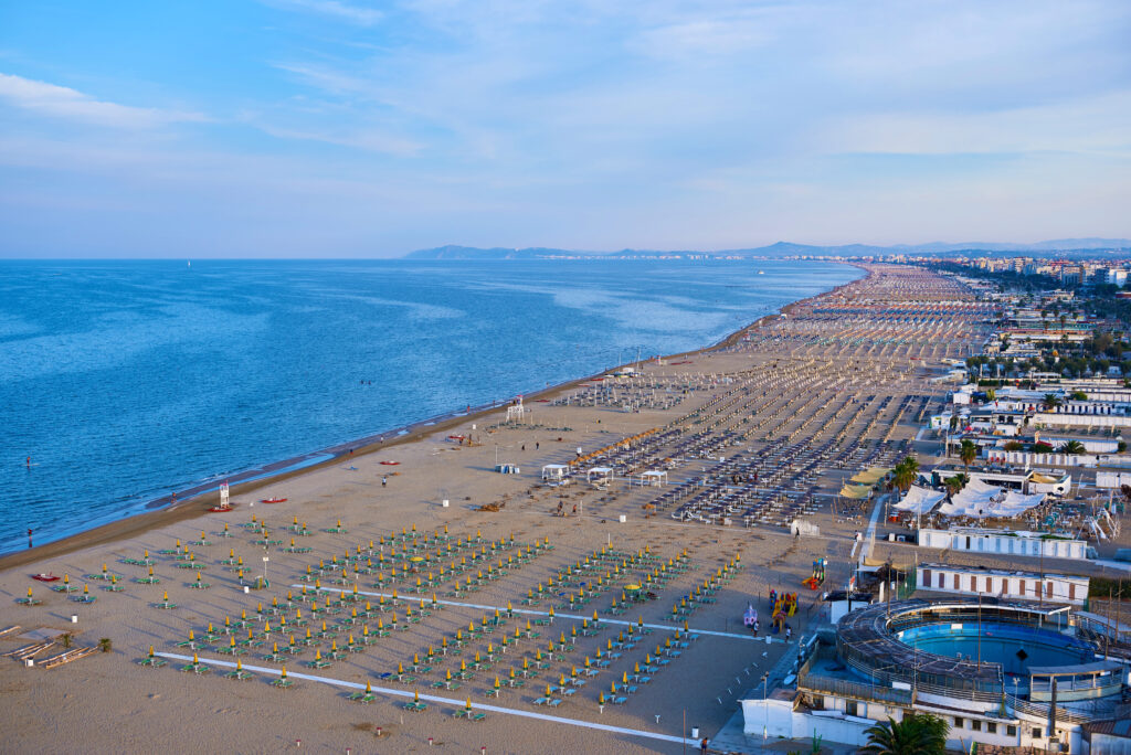 Aerial view of Rimini beach with people and blue water.