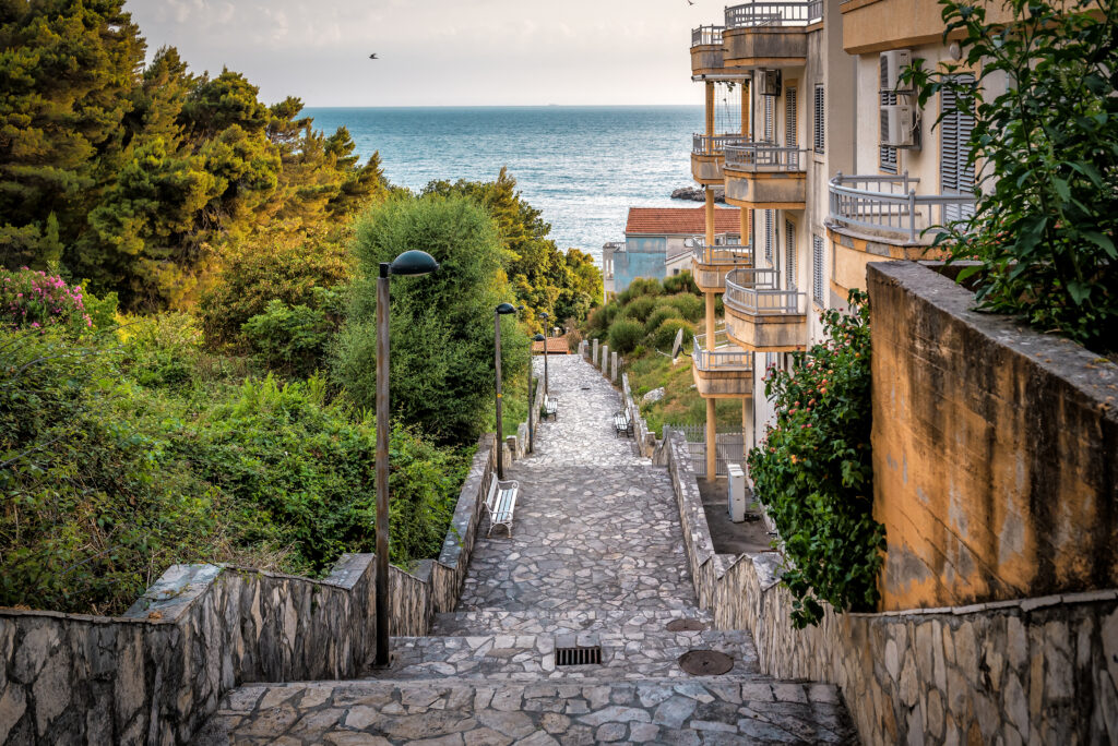 Stone stairs leading down to the sea. Ancient stone steps in Sveti Stefan. Budva. Montenegro