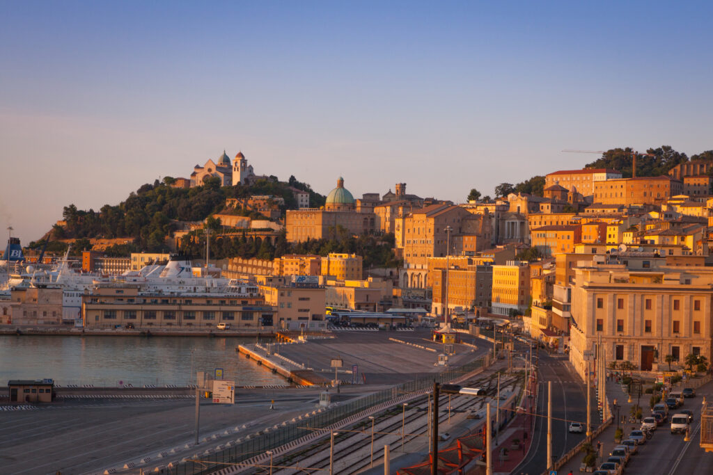 Ancona, Italy - August 28, 2015: View towards the ferry terminal and the historical city center of Ancona in central Italy. The port has regular ferry links to Croatia, Albania and Greece. The hillside is dominated by the 13th century landmark church, the cathedral of San Ciriaco.