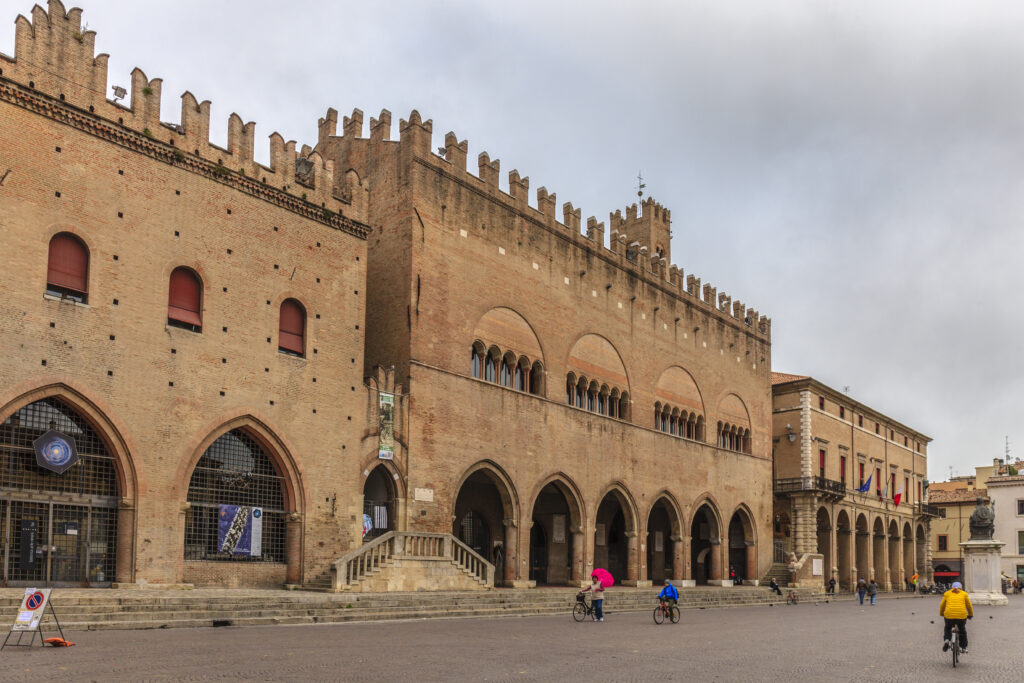 Rimini, Italy - October 23, 2014: Local people strolling in Piazza Cavour in a cloudy day of end October. The city square is the political and economic center since the beginning of the thirteenth century, when were built some imposing palaces still visible.